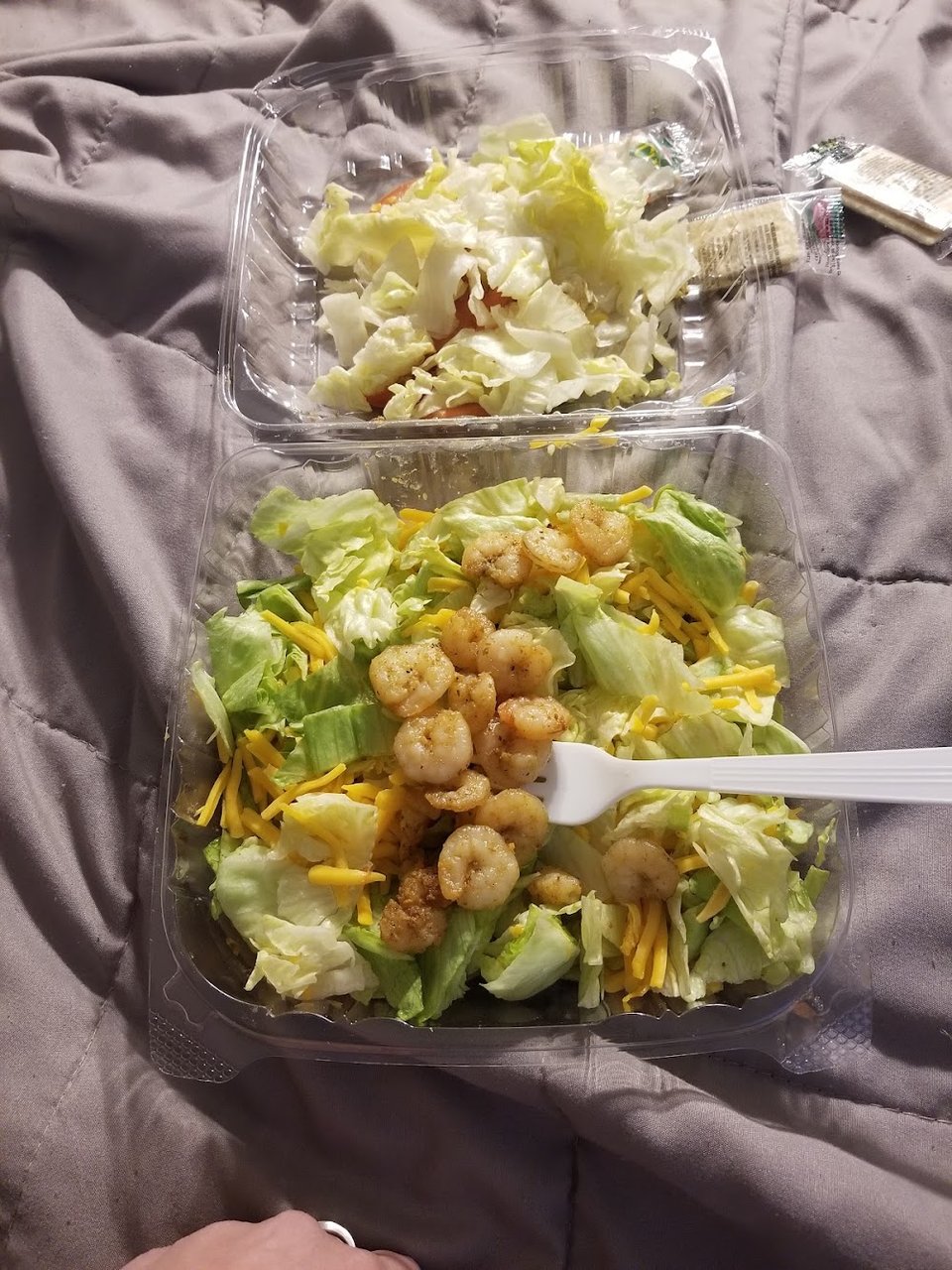 Counter menu with burgers, salads, and fries.